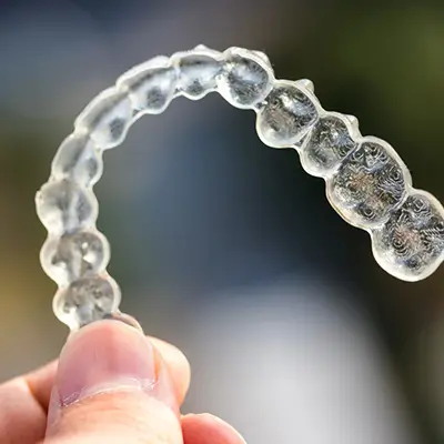 Orthodontist Vaughan Close Up Holding Invisalign Aligners